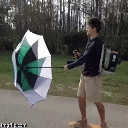 guy with umbrella on skateboard